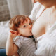 Shows an image of a woman breastfeeding her infant