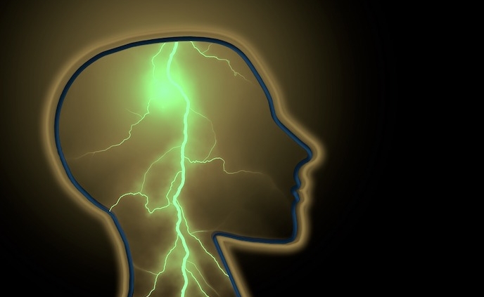 Shows the side profile of a human head with a bolt of lightning in the center of it.